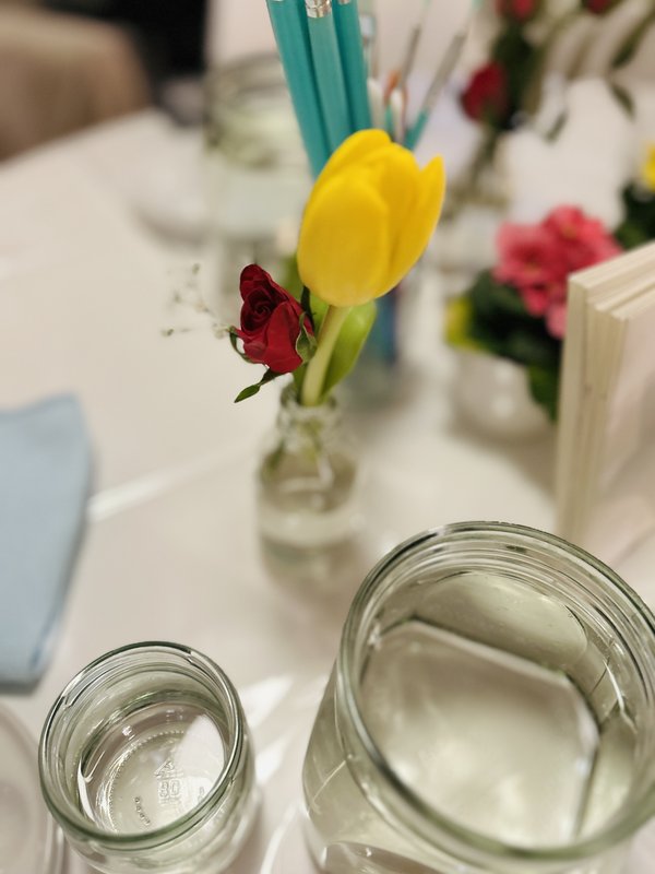 Small glass vase with a red rose and yellow tulip